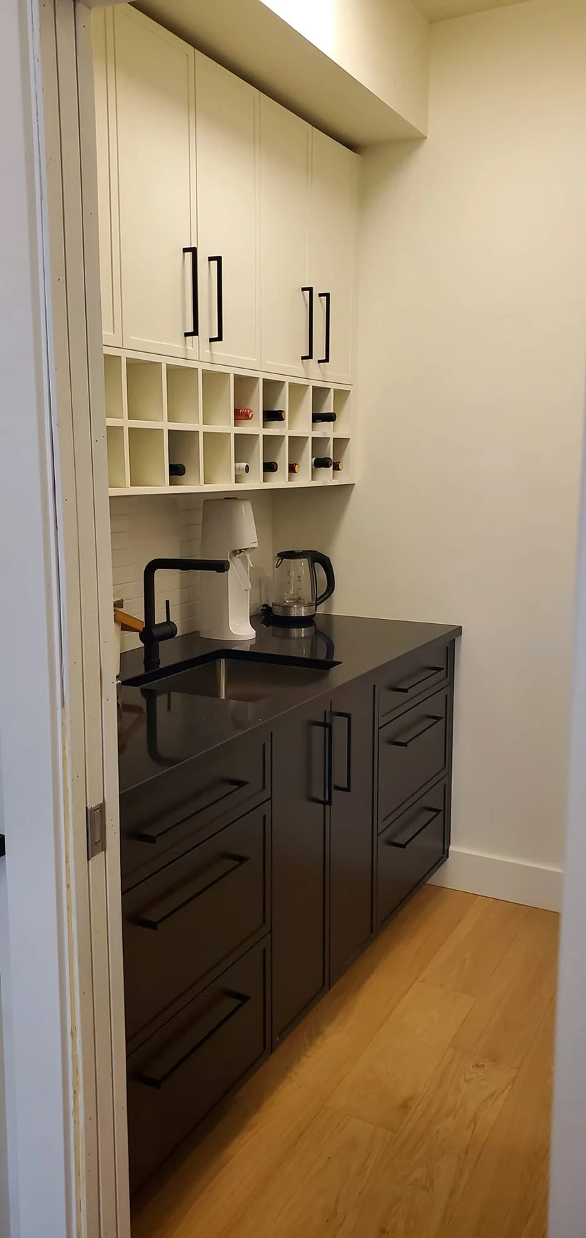 Compact butler's pantry with sink and wine cubbies