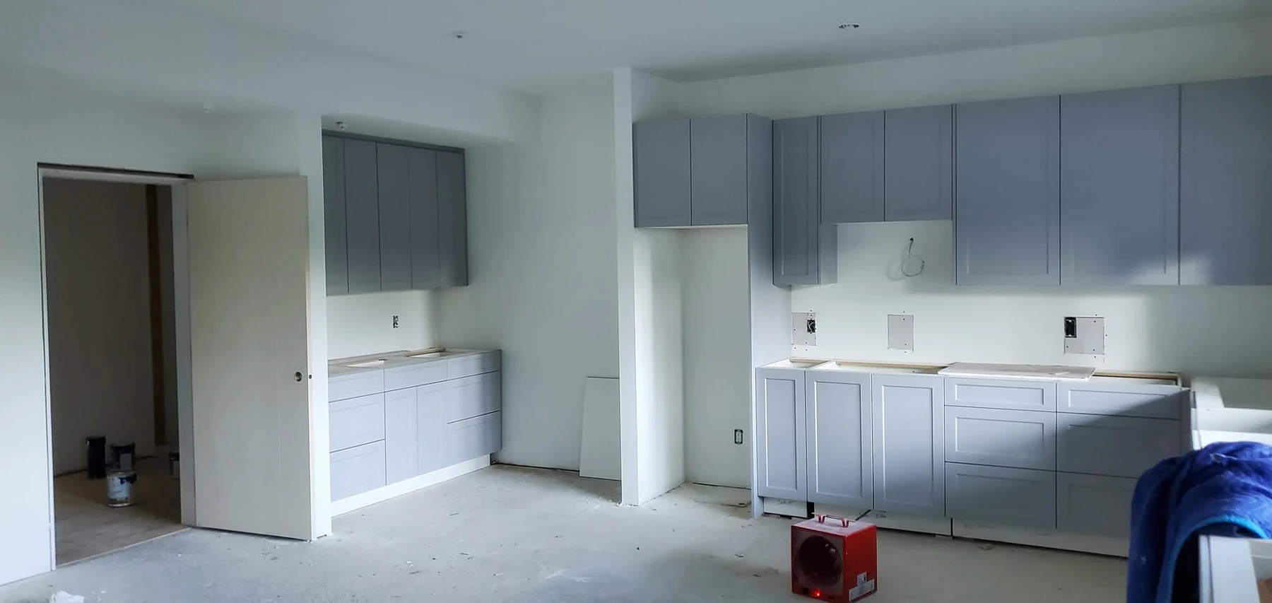 Laundry and utility cabinetry installation in progress