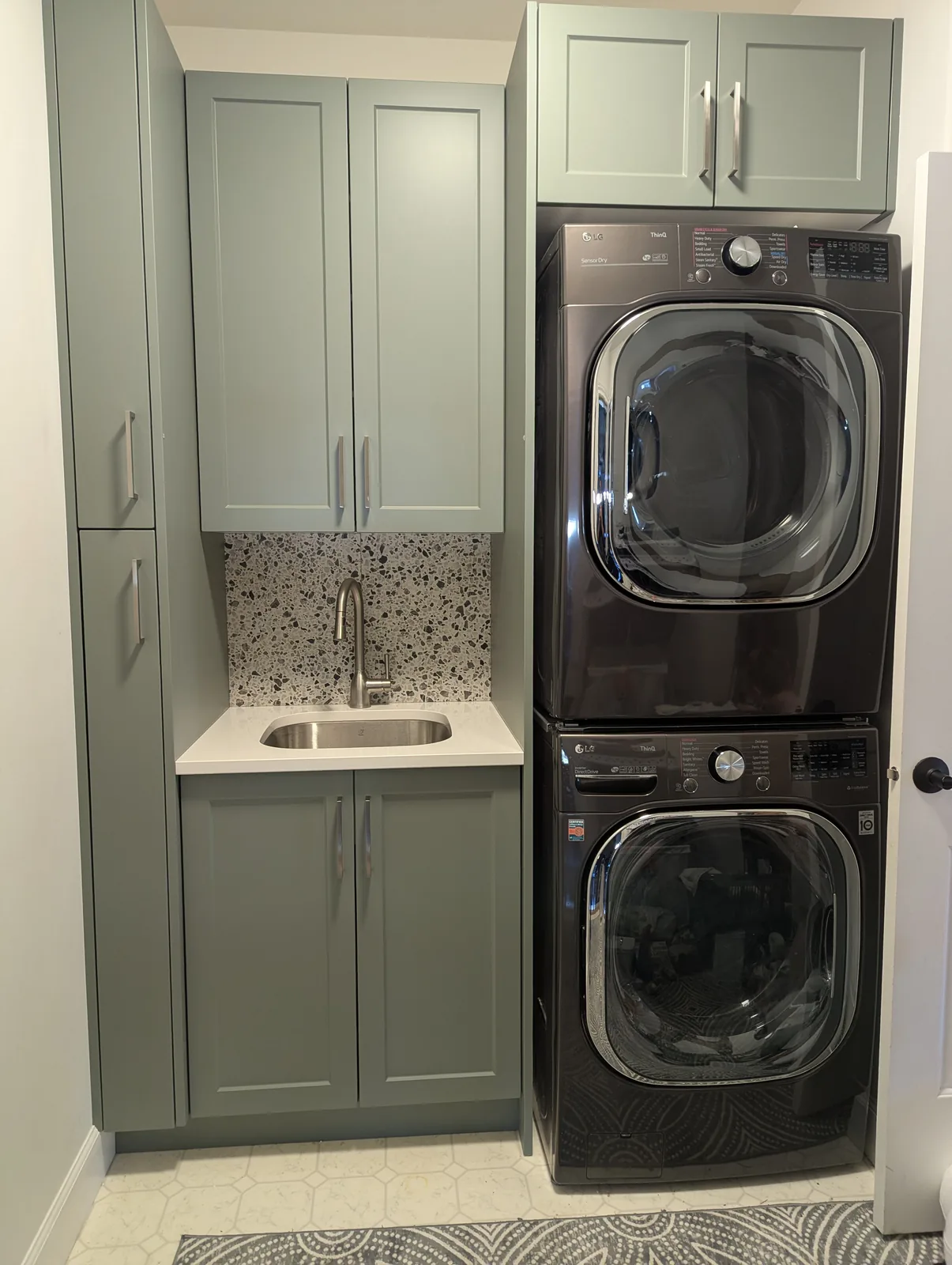 Laundry room cabinetry around stacked washer and dryer