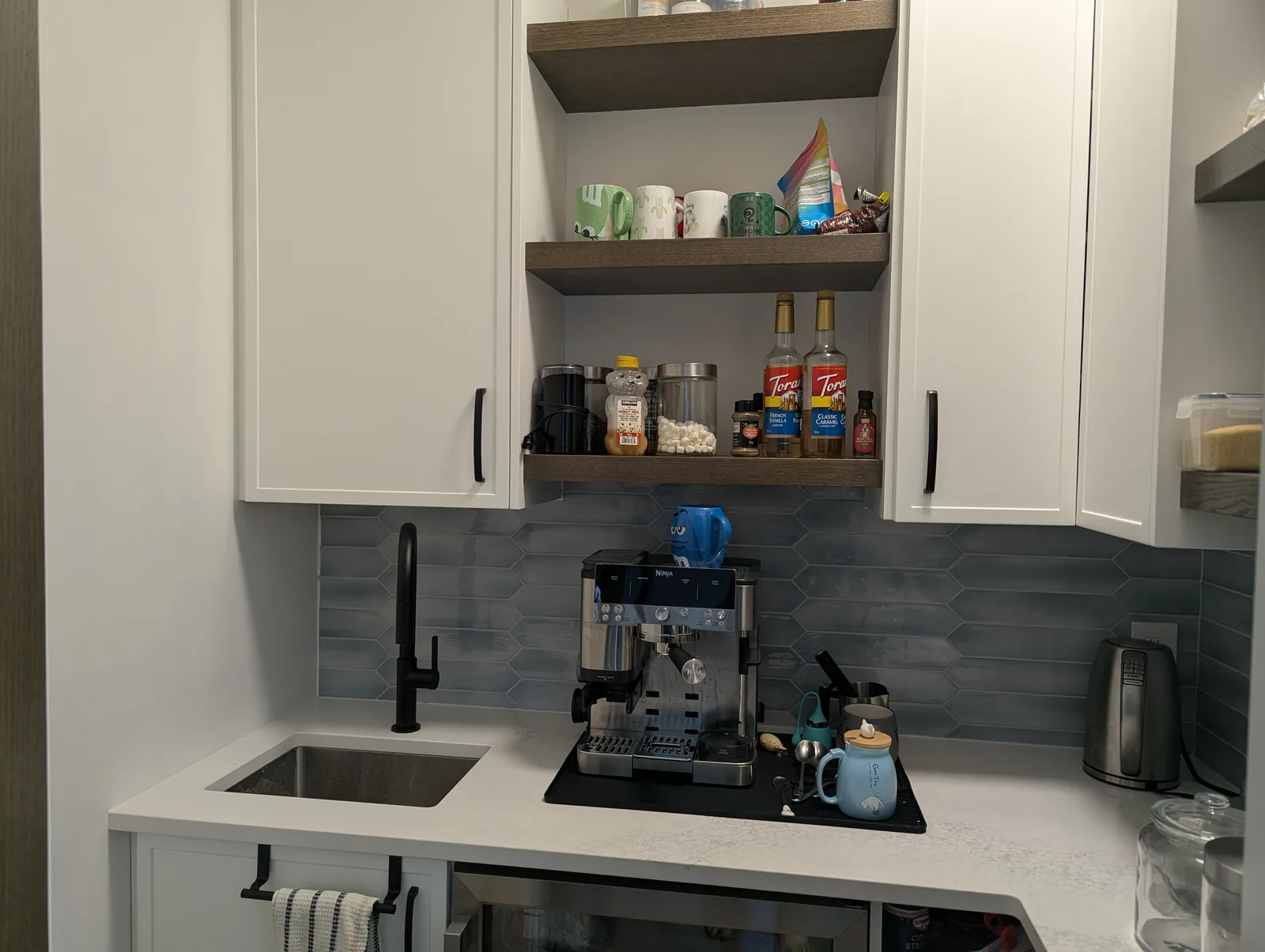 Custom walk-in pantry coffee bar with shelving